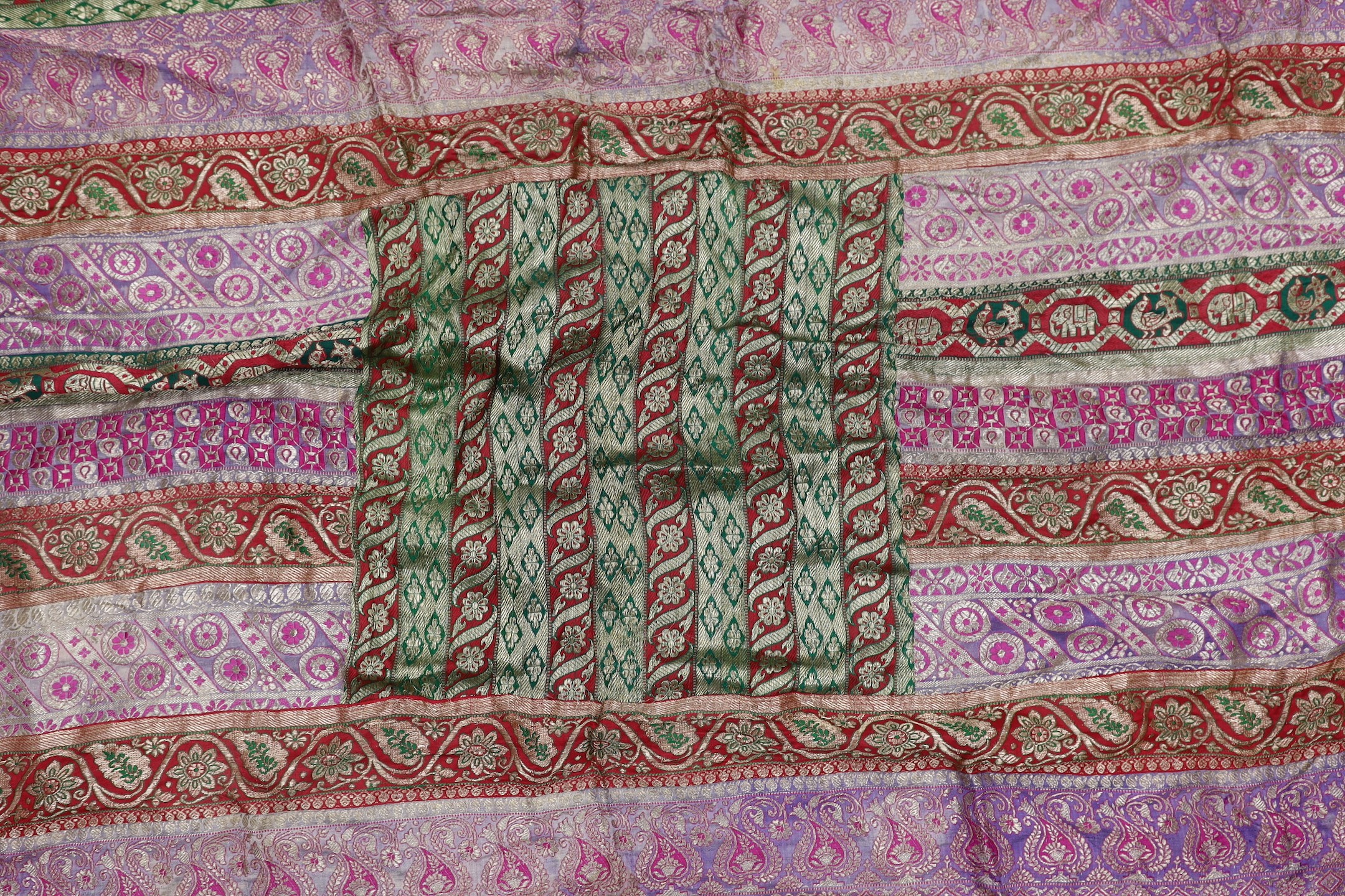 A French 18th century woolwork cushion, 2 chair covers, another panel, a tasselled brocade cushion and an Indian metallic brocaded patchworked cover